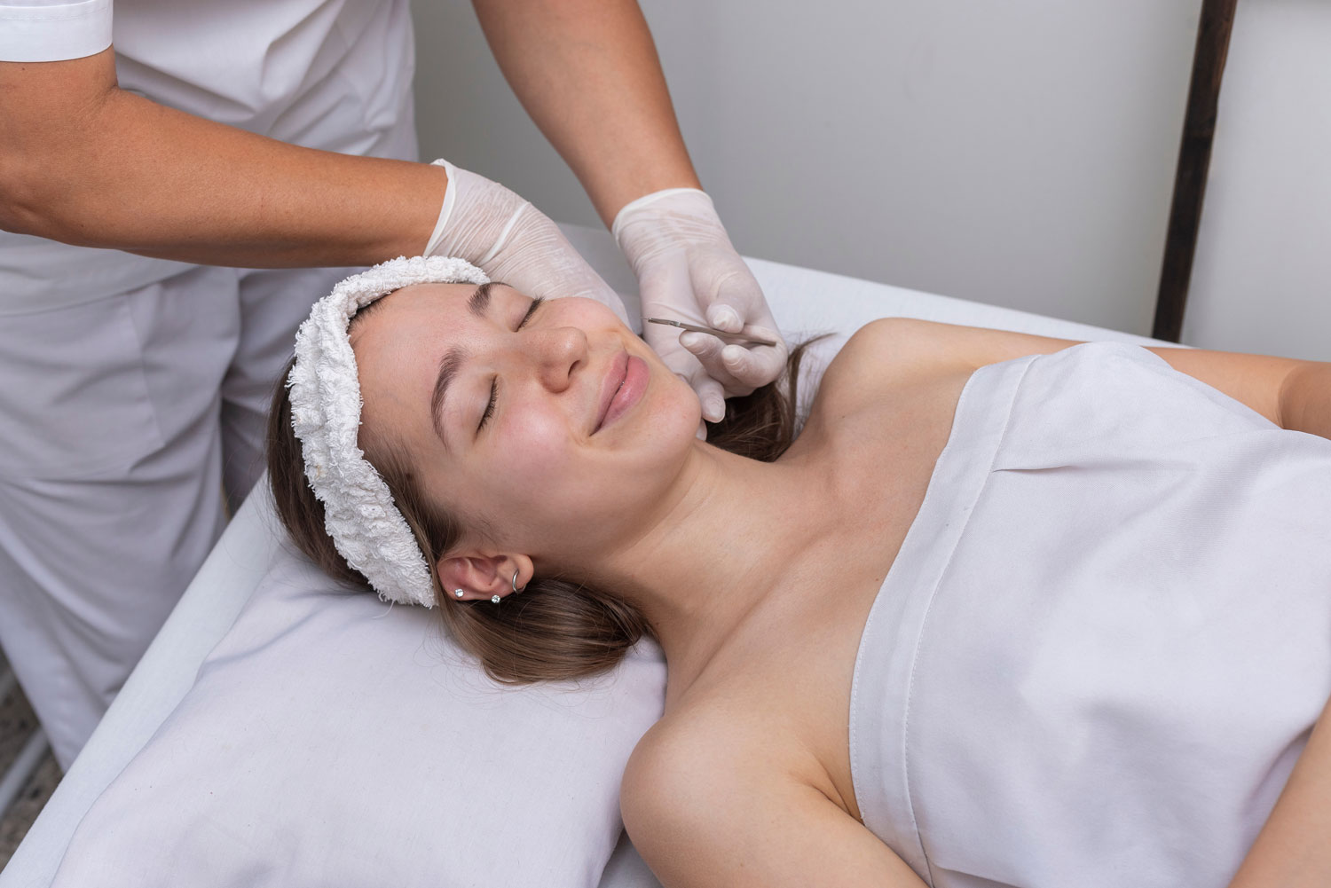 Woman having a dermaplaning and led light therapy at Sunflower Spa