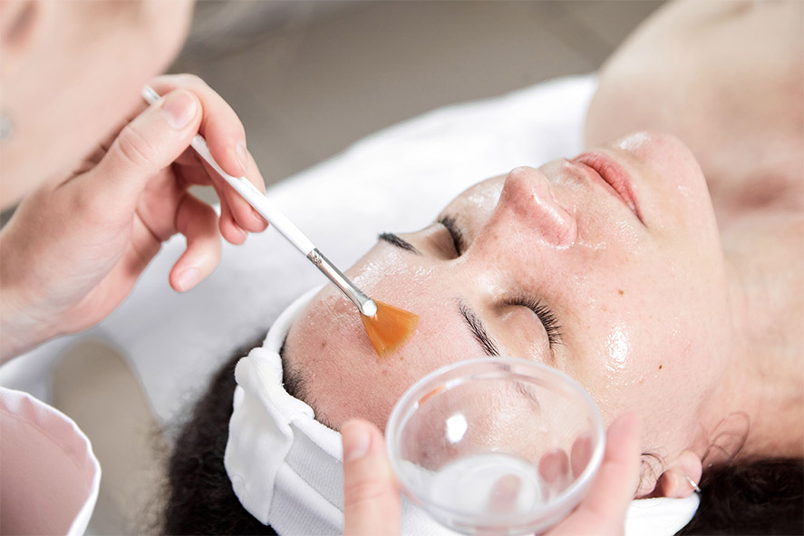 Black haired woman having VI Peel treatment at Sunflower Spa