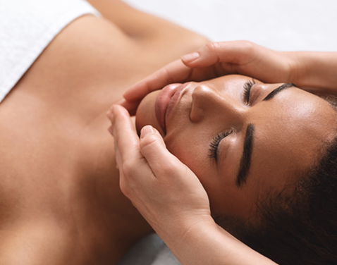 Black haired woman having a facial treatment