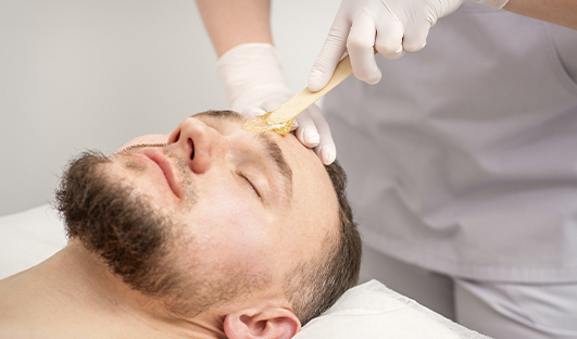 Man having a facial waxing at Sunflower Spa